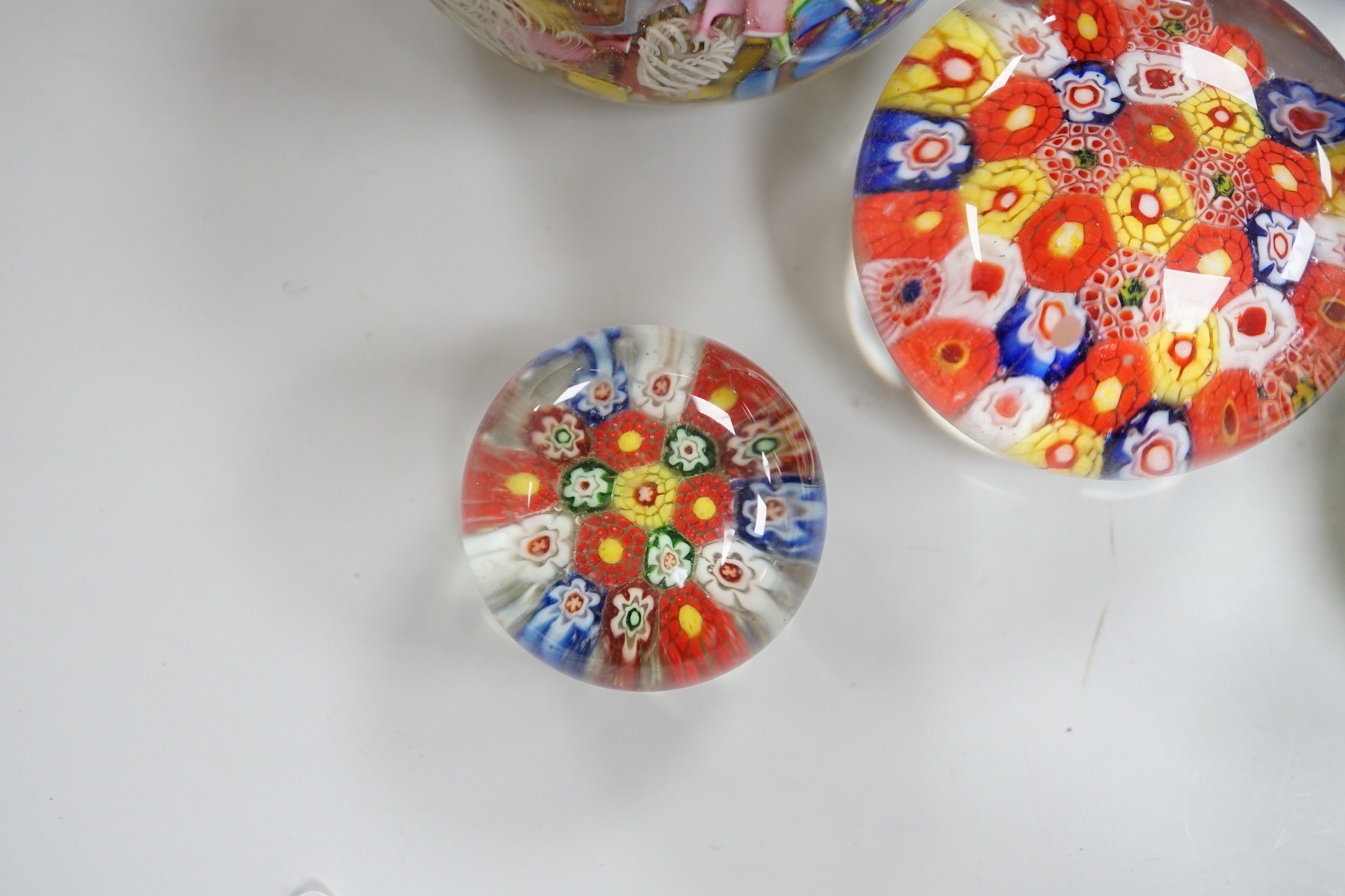 An Orient and Flume glass paperweight, a Venetian scrambled glass paperweight, and three Chinese paperweights, largest 7cm tall